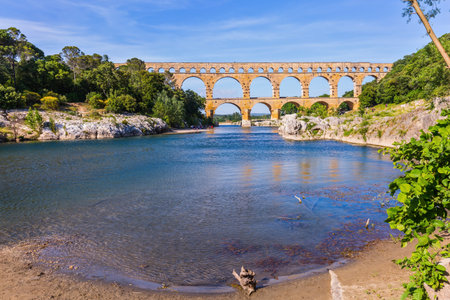 The bridge was built in Roman times on the river Gardon. Three-tiered aqueduct Pont du Gard - the highest in Europe. Provence, spring sunny dayの写真素材