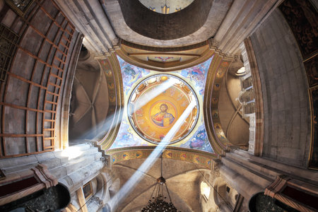 Facilities in the Holy Sepulchre.  The magnificent round arch of a ceiling is shined with two bright beams of the sun. On a ceiling image of the Christ Saviorのeditorial素材