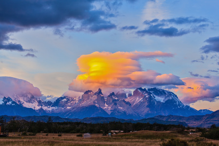 The clouds are illuminated by the sun on the rocks Los Quernos. Incredible sunset in the national park Torres del Paine, Chileの写真素材