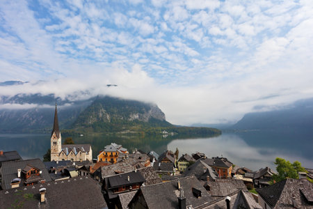 The most picturesque small town in Austria - Hallstatt. Slender bell tower and the church on the shore of Lake Hallstattのeditorial素材