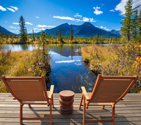 Two comfortable wooden chairs and a small round table on the lake. Concept of ecological tourism....