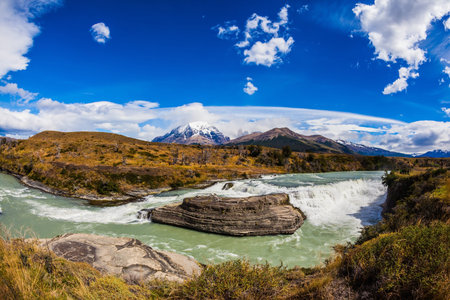 Chile, Patagonia, Torres del Paine National Park - Biosphere Reserve. Cascades Paine. Cold emerald water of the river Paine with a roar there pass rocky barriersの写真素材