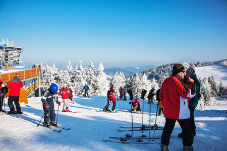 SKI CENTER KOHUTKA, CZECH REPUBLIC - JANUARY 16, 2010: Ski resort in the Czech Tatra.  Frosty sunny winter day. Skiers in bright jackets are preparing to descend on skisのeditorial素材