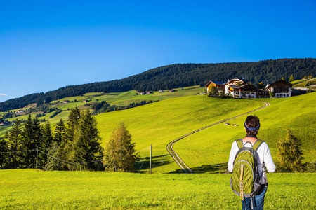  Active elderly woman-tourist with backpack admiring the beauty of the Dolomites. Northern Italy, Tirol. The concept of an active and eco-tourismの写真素材