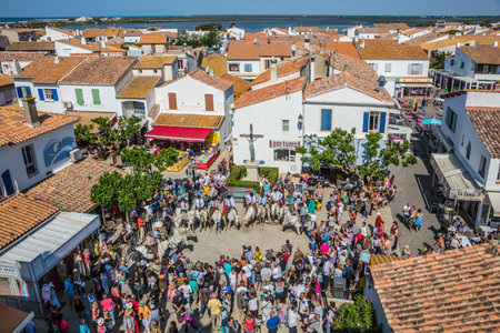 Saintes-Maries-de-la-Mer, France - May 25, 2015. Feast in honor of the Holy Maries in Provence. Guards on white horses before start of the parade. The concept of ethnographic tourismのeditorial素材
