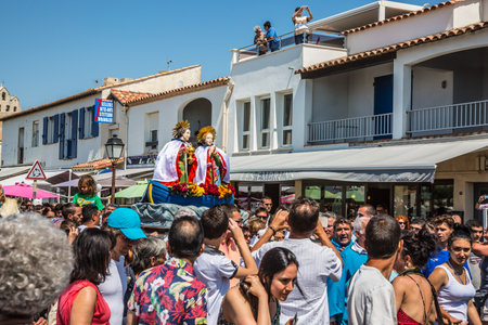 Saintes-Maries-de-la-Mer, France - May 25, 2015. Religious feast in honor of the Holy Maries in Provence. The concept of ethnographic tourism. The crowd is accompanied by two statues Holy Mariesのeditorial素材
