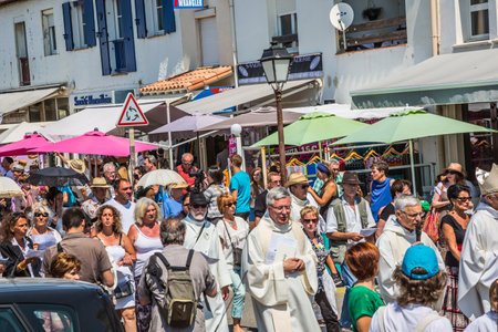 Saintes-Maries-de-la-Mer, France - May 25, 2015. Religious holiday in honor of the Holy Maries in Provence. The concept of ethnographic tourism. Participants of a procession bear bannersのeditorial素材