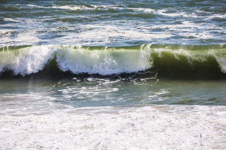 The concept of extreme and exotic tourism. Ocean surf with foamy waves. Atlantic coast of Walvis...