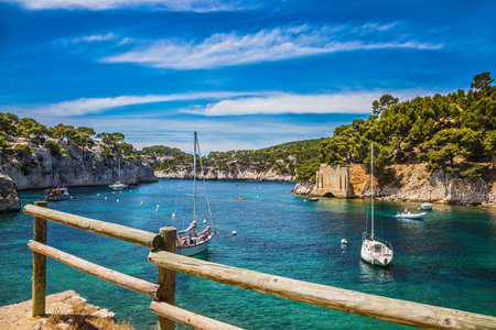 Narrow fjords between stony coast. White sailing yachts wait for the owners.  National Park Calanques on the Mediterranean coastのeditorial素材