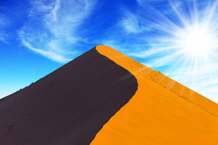 Namibia, South Africa, sunset. Hot sun of the Namib desert. Orange and  purple dune. The concept of extreme and exotic tourismの写真素材