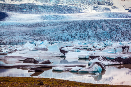 Sunset illuminates the glacier. Glacier provides water Ice Lagoon Jokulsarlon. The concept of...