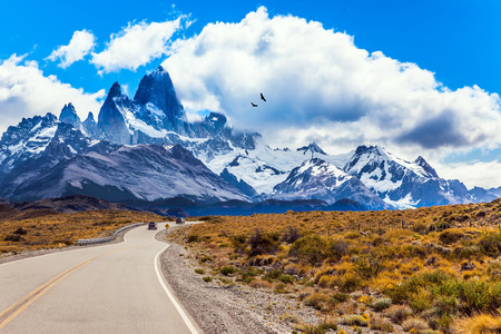 Argentine Patagonia. Summer day in February. Fine highway to the majestic Mount Fitz Roy. The concept of active and extreme tourism. The huge black Andean condors hover over the prairieの写真素材