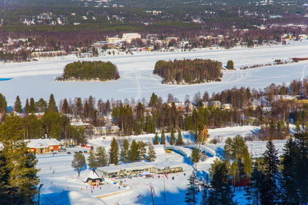 Tourist entertainment village in Lapland. The picture was taken from a bird's eye view. Journey to Santa Claus. Bright frosty winter day. Concept of active and ecological tourismのeditorial素材