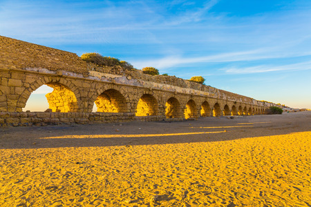  "High" aqueduct, built under the reign of Herod the Great. Concept of active, ecological and historical tourism. Fantastic sunset on the Mediterranean coast in Caesareaの写真素材