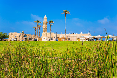 Ruins of the ancient port of Caesarea. Israel. Sunny spring day. The restored minaret of the times of the Arab invasion. Concept of archeological and historical tourismの写真素材