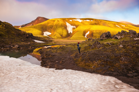 Magic sunrise in the Arctic. The golden light of dawn illuminates the mountains and glaciers national park Landmannalaugar, Icelandの写真素材