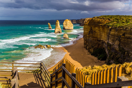 Observation deck on coast. Fabulous morning light on the Pacific coast near Melbourne. The well-known rocks Twelve Apostles in an ocean storm surf. The concept of active and phototourismの写真素材