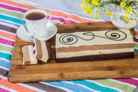 Three-layer chocolate cake, decorated with chocolate patterns.  Holiday cake Three-colate....