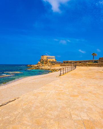 Concept of ecological and historical tourism. The ruins of the port in ancient Caesarea and the restored embankment. Excursion to the Archaeological Park of the Roman Empireの写真素材