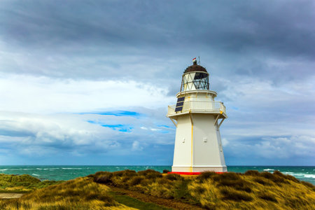 Independent trip to New Zealand. The snow-white lighthouse of Waipapa is visible on the horizon....