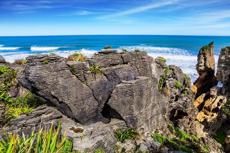 The magic of a faraway country. Travel to New Zealand. Stone flat "pancakes", stacked on top of each other.West Coast of the South Island, Paparoa Park. The concept of ecological, active and phototourismの写真素材