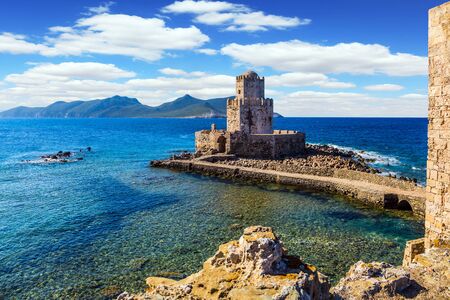 Magnificent three-tiered watchtower built on long cape in the sea. Venetian fort castle Methoni on the Greek Peninsula Peloponnese. The concept of active, photo and historical tourismの写真素材