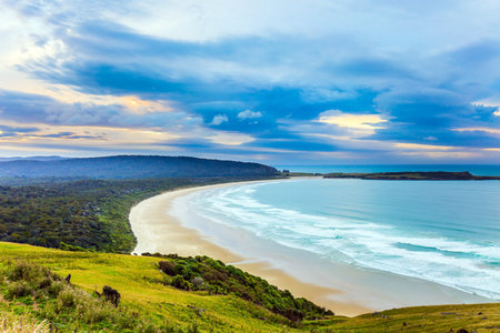 Evening twilight on the sandy beach. The picturesque Pacific coast of the South Island. Fantastic New Zealand. The concept of ecological, exotic, active and phototourismの写真素材