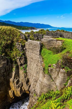 Journey to the ends of the world. Stone flat "pancakes", stacked on top of each other. Pancake Rock is a natural wonder of Paparoa National Park, New Zealand. The concept of ecological, active and photo tourismの写真素材