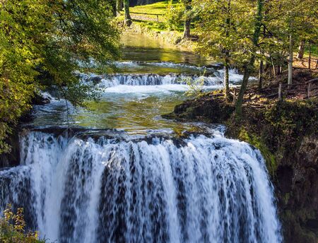The small Croatian town of Slunj. The concept of ecological, active and photo tourism. Magnificent cascade of waterfalls on the Korana River. The forest surround the city and the riverの写真素材