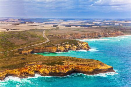 Scenic coastline. Picture taken from a helicopter. Great Ocean Road and the Twelve Apostles is a group of limestone cliffs. Port Campbell Park, Australia. The concept of extreme, active and photo tourismの写真素材