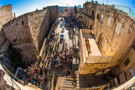 Tourists and pilgrims visit the ancient city. Bird's eye view. Sunset. Jaffa Gate Old Town in holy Jerusalem. The concept of historical, religious, pilgrim and photo tourism. Lens Fisheyeのeditorial素材