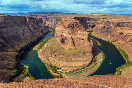 Scenic horseshoe-shaped bend of the Colorado River. Horseshoe Bend - the famous landmark of Arizona. USA. The concept of active, extreme, ecological and photo tourismの写真素材