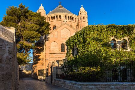 Cathedral of the Armenian Church in Jerusalem. Hot summer sunset. The cathedral is lit by the setting sun. The concept of religious, historical and photo tourismの写真素材