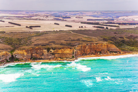 Scenic coastline. Picture taken from a helicopter. Great Ocean Road and the Twelve Apostles is a...