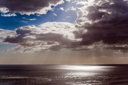 Magnificent thunderclouds over the Pacific Ocean. North Island, New Zealand. Sunset on Murivay Beach. The concept of environmental and photo tourismの写真素材