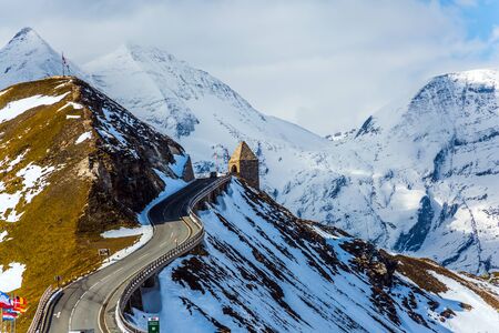 Turret at the turn of the road. Grand Austrian Alps. Alpine panoramic mountain road Grossglocknerstrasse. Snow melts. The concept of active, ecological and photo tourismの写真素材