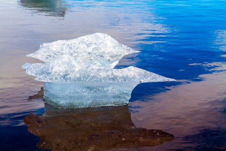  Ocean surf brings ice floes. The famous icelandic black sand beach. Iceland. Cold day in North...
