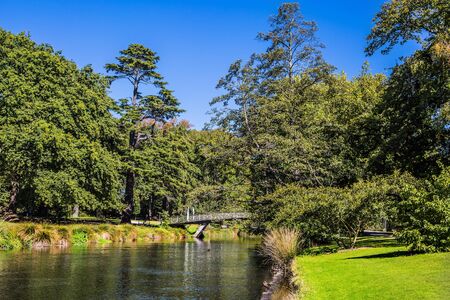 Christchurch Scenic Garden. Beautiful day in early autumn. Rather quiet river flows through the park. Travel to New Zealand, South Island. The concept of ecological and photo tourismの写真素材