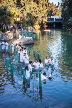 YARDENIT, ISRAEL - JANUARY 21, 2012: Christian pilgrims enter Jordan River waters. They make  baptism ceremony in honor of Jesus Christ's baptism hereのeditorial素材