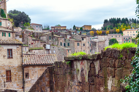 Italy, southern Tuscany. The tufa city of Sorano is enchanted city from a fairy tale. Tiled roofs of...