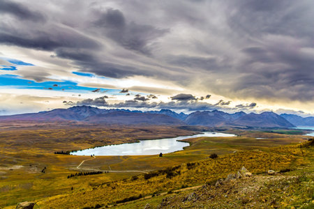 Travel to a faraway country. New Zealand, South Island. Lake Tekapo on cloudy day. The lake in the...