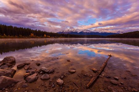 Pink sunrise. Majestic lake Patricia in Jasper National Park, Rocky Mountains of Canada. The concept of active, northern and photo tourismの写真素材