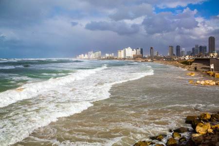 Storm on the Mediterranean Sea. Huge waves with crests of white foam collapse on Tel Aviv. Cold and...