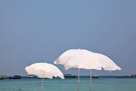 The tropical azure sea. Picturesque snow-white beach umbrellas on a sea wind
の写真素材