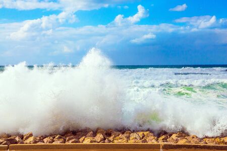  Huge six-meter waves with crests of white foam collapse at the Old Port of Jaffa in Tel Aviv. Storm on the Mediterranean Sea. The winter in Israel. The concept of active, environmental and photo tourismの写真素材