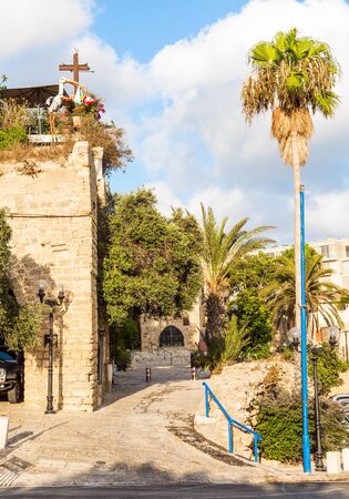 Old Yaffo - one of the most ancient cities of the world. Warm summer evening. Century masonry walls. Doors bound by metal bars. Sunset. Concept active, informative and photo of tourismの写真素材