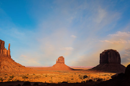 Monument Valley is a unique geological formation in USA. Number of rocks - outcrops made of red sandstone. The concept of environmental and photo tourismの写真素材