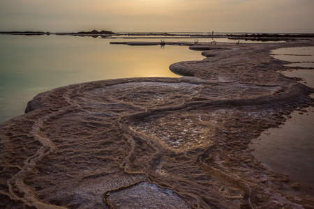  The sky merges with the sea on the horizon. Israel. Dim winter day over the Dead Sea. Evaporated salt protrudes above water. The concept of active and photo tourismの写真素材