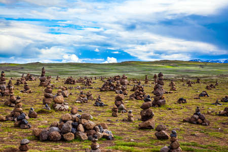 The symbol of Iceland is the stone pyramids. Field of stone pyramids. Stone pyramids bring good luck in the journey. Cloudy summer day. The concept of active, ecological and exotic travelの写真素材