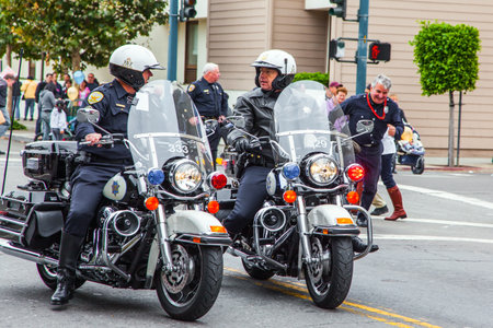 SAN FRANCISCO, USA - OCTOBER 11, 2009: Equestrian parade in honor of the holiday. Columbus Day celebration. Two police officers on motorcycles accompany the festive processionのeditorial素材